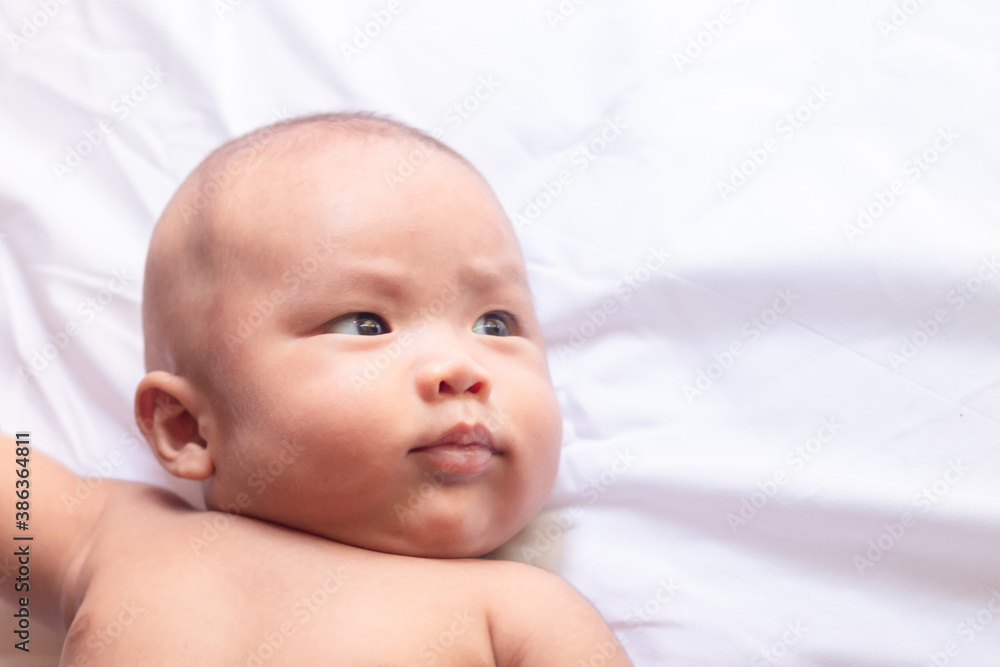 Baby boy lying on a bed sleeping. Baby boy lying on a bed sleeping.