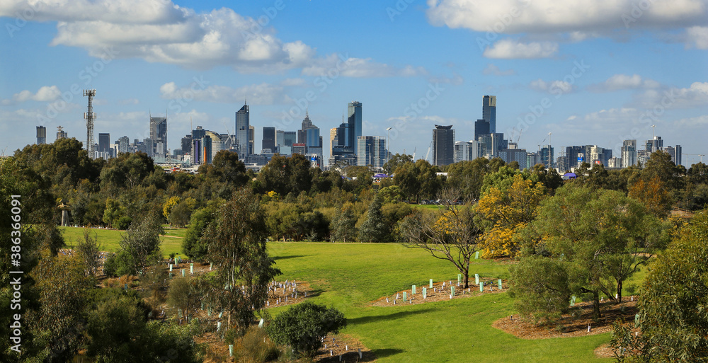 Skyline view across a park of the city of Melbourne in Victoria, Australia. 