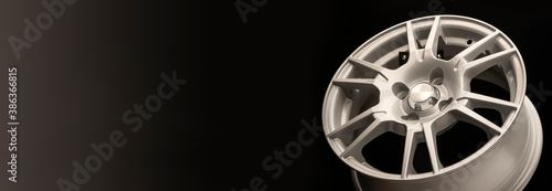 New silver alloy wheel on a black background,panoramic photo for the site header or advertising, copy space