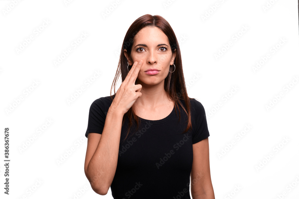 Isolated in white background brunette woman saying fear in spanish sign language Isolated in white background brunette woman saying fear in spanish sign language