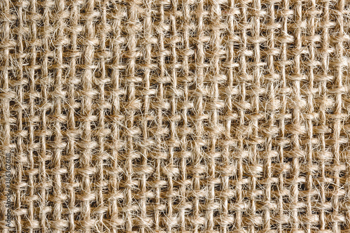 Natural brown linen fabric background. Fiber structure texture. Vintage canvas pattern.
