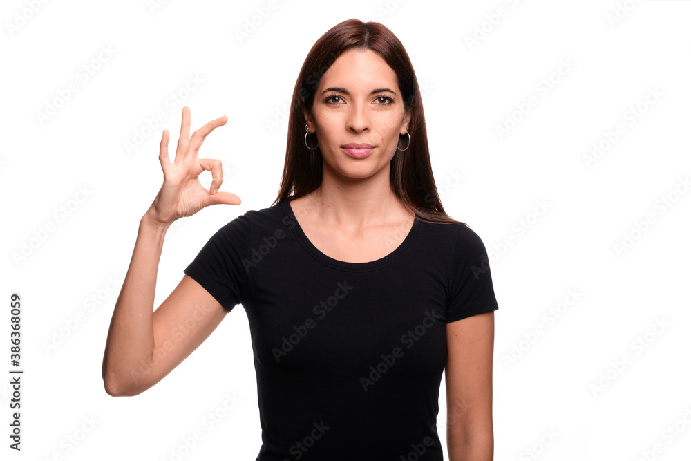 Isolated in white background brunette woman saying letter S in spanish sign language Isolated in white background brunette woman saying letter S in spanish sign language