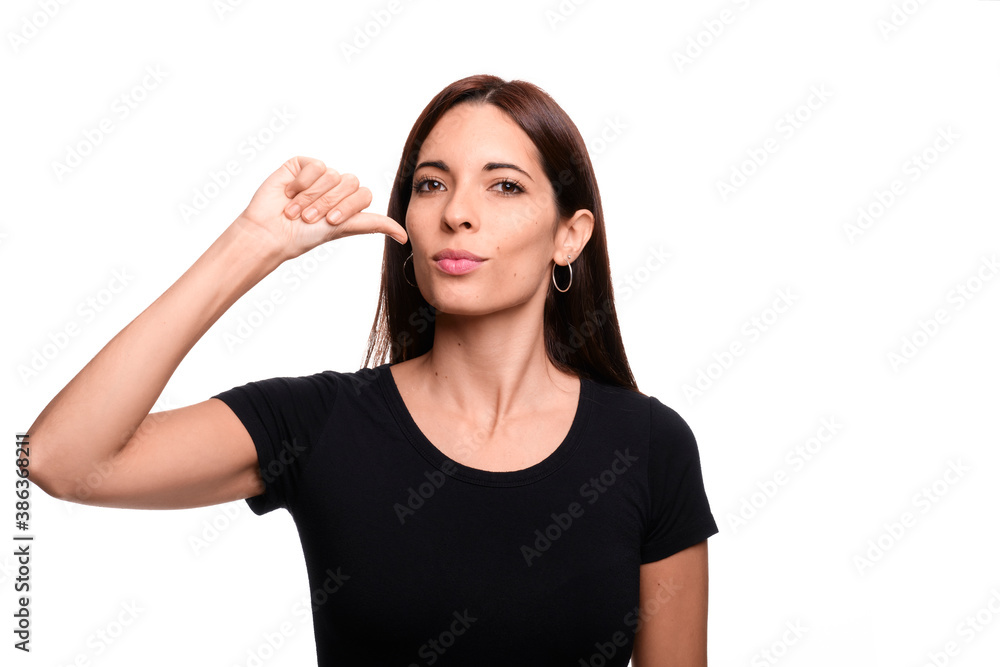 Isolated in white background brunette woman saying drink in spanish sign language Isolated in white background brunette woman saying drink in spanish sign language