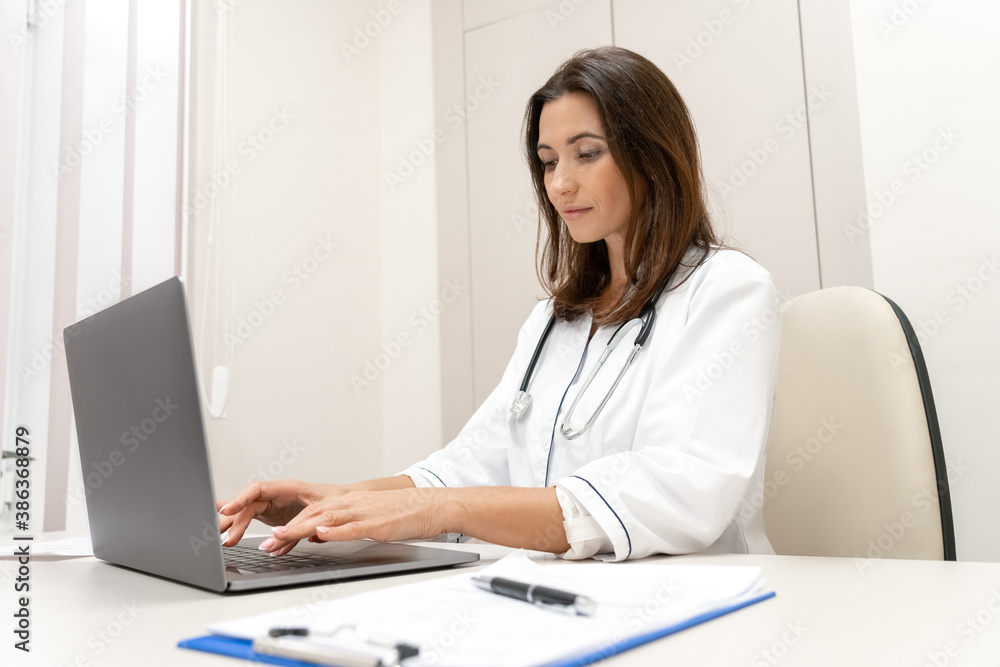 Doctor explaining with patient via laptop computer, mobile health application. Doctor explaining with patient via laptop computer, mobile health application.