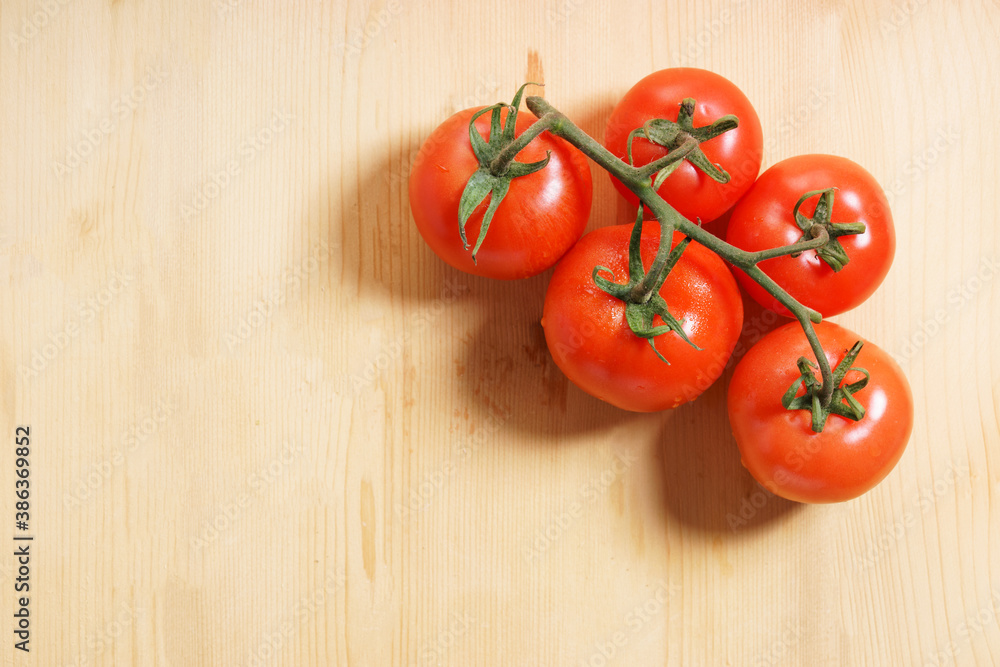 Wet red tomatoes on wooden background. Wet red tomatoes on wooden background.