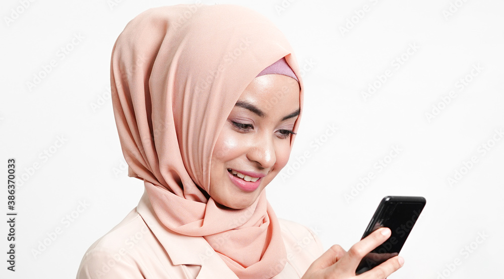 Muslim woman playing smartphone. technology concept. Muslim woman playing smartphone. technology concept.