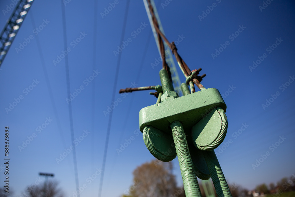 Selective focus on screw and thread tightening steel cables. It is part of the construction of the transmission line for the transmission of high voltage electricity. Copy space. Selective focus on screw and thread tightening steel cables. It is part of the construction of the transmission line for the transmission of high voltage electricity. Copy space.