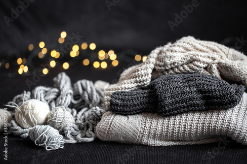 Composition with knitted items on a dark cozy background.