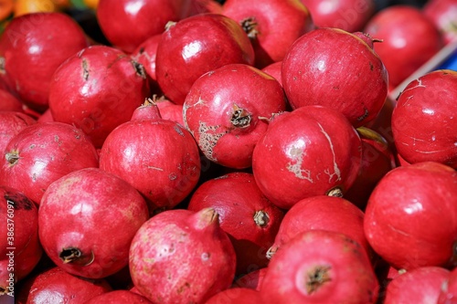 pomegranates -close-up of fruit and vegetables for sale at the market
