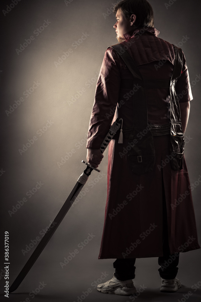person in jacket with sword standing back person in jacket with sword standing back