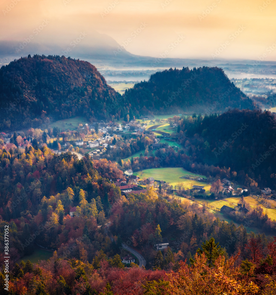 Fabulous autumn view of Slovenian resort town - Bled. Mystical sunrise in Julian Alps, Slovenia, Europe. Traveling concept background..