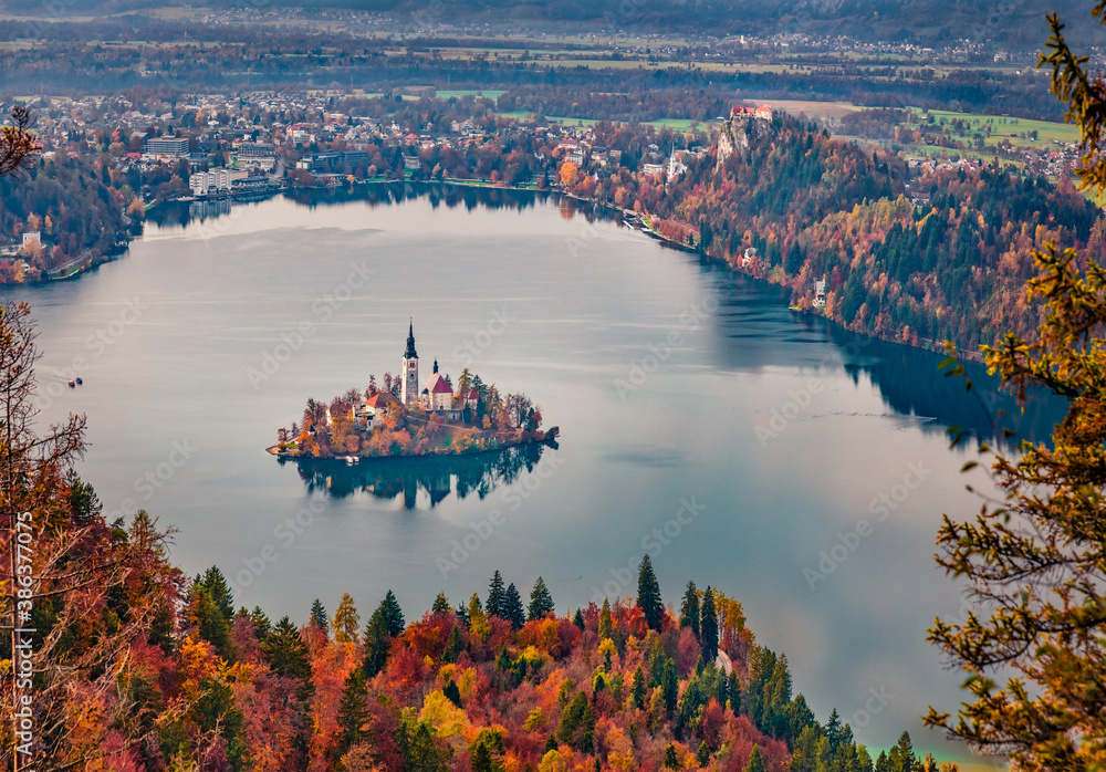Aerial morning scene of church of Assumption of Maria. Scenic autumn view of Bled lake. Calm autumn landscape of Julian Alps, Slovenia, Europe. Traveling concept background.