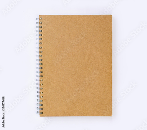 Blank recycled paper cover notebook top view on white desk background