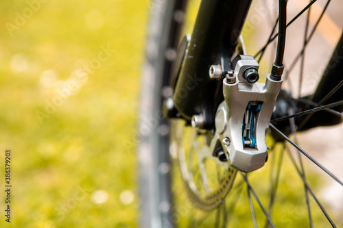 Close-up of a mountain bike brake system. See worn brake disc and hydraulic brake mechanism. Copy space