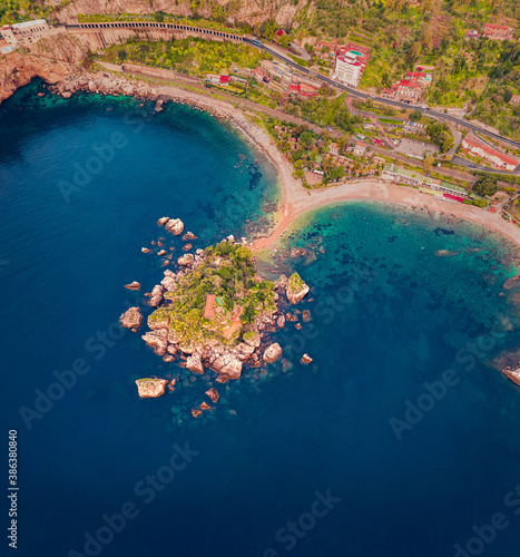 View from flying drone of Bella island. Colorful spring seascape of Mediterranean sea, Mazzaro' town, Sicily, Itale, Europe. Top down view. Traveling concept background. photo