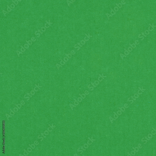 A green vintage rough sheet of carton. Recycled environmentally friendly cardboard paper texture. Simple and bright minimalist papercraft background.
