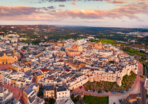 Picturesque spring view from flying drone of Ostuni town, Italy, Europe. Stunning sunrise on Apulia. Traveling concept background. Splendid morning cityscape of Ostuni.