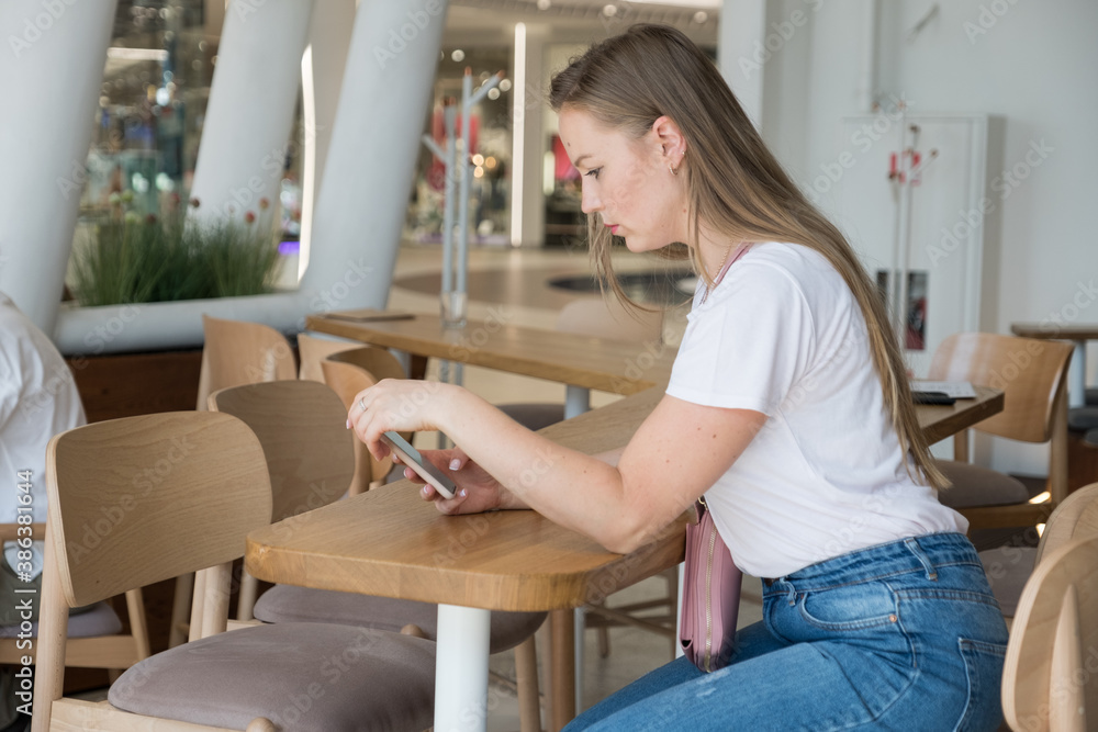 Woman sitting in cafe drinking coffee and planing her agenda. She alone in beautiful place, relaxing and dreaming about future. Woman sitting in cafe drinking coffee and planing her agenda. She alone in beautiful place, relaxing and dreaming about future.