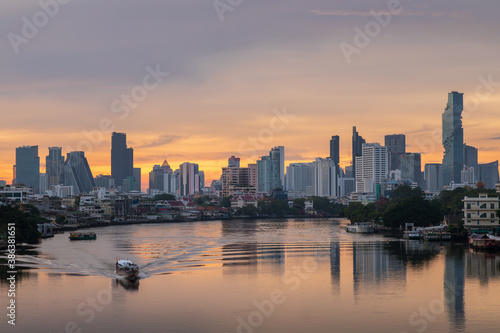 Bangkok city center financial business district, waterfront cityscape and Chao Phraya River during twilight before sunrise, Thailand