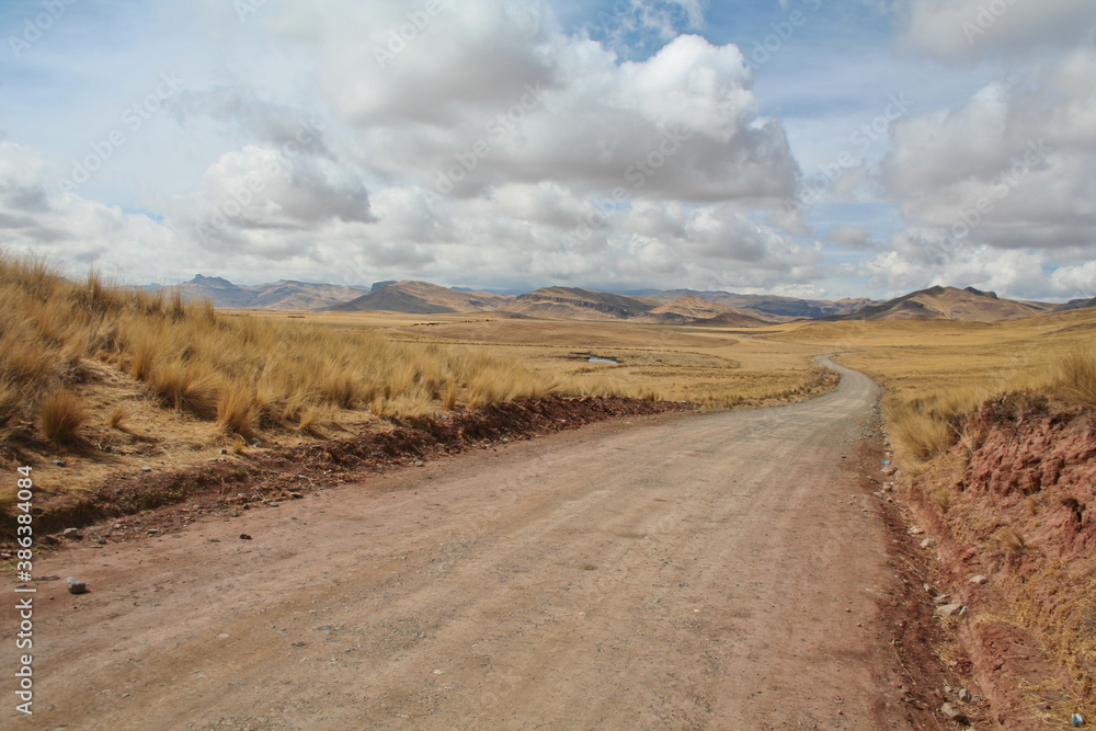 Lonely dirt road near Tinajani canyon in peruvian Altiplano between Puno and Cusco in South America's Andes.