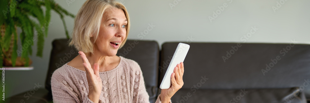 Middle age woman holding computer at home. Middle age woman holding computer at home.