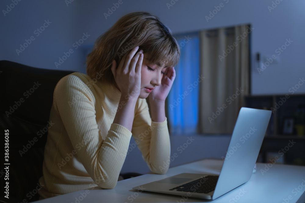 Asian woman she is stressed and has a headache. With reading news in social networks Asian woman she is stressed and has a headache. With reading news in social networks