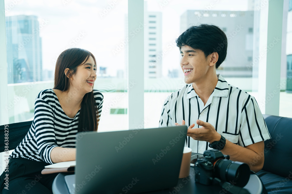 Two influencers doing live video streaming with computer laptop together. Two influencers doing live video streaming with computer laptop together.