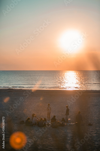 Sunset at the beach with group of people