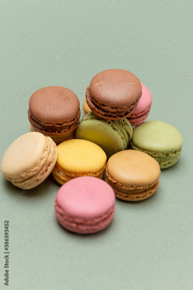 Colored tasty macaroons over a green background. Colored tasty macaroons over a green background.