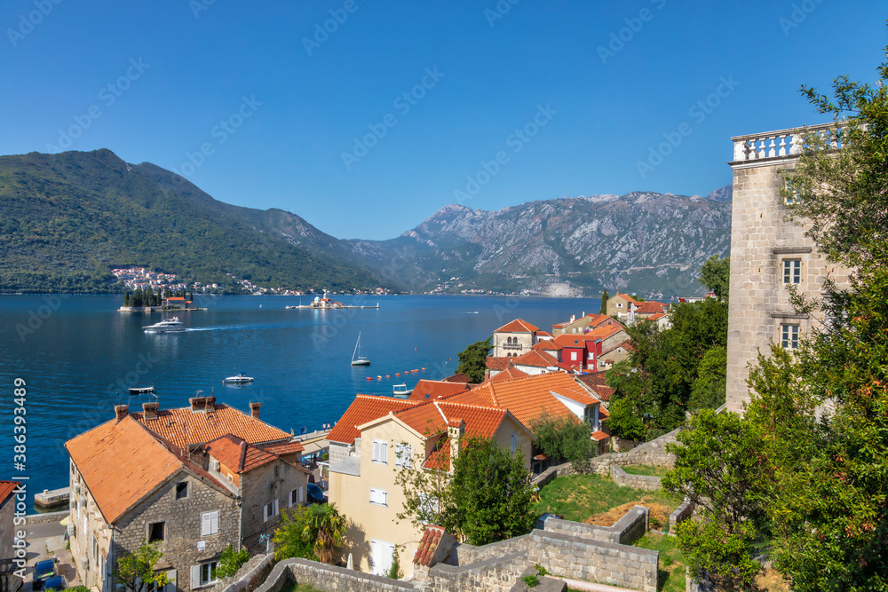 Top view of the houses and streets of the old coastal town of Perast, located in the Bay of Kotor, Montenegro.