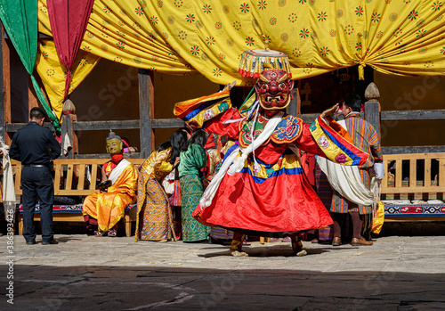 Bhutan, in the village of Bumthang, a monk mask dancer in his colourful costume dances at the festival of Jakar.