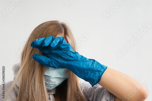 Woman in a protective mask and protective gloves. Coronavirus pandemic.	
