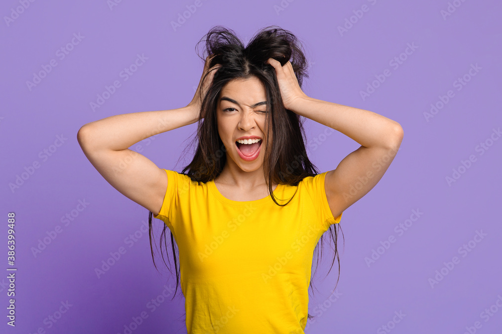 Mad Mood. Crazy Asian Woman Touching Tousled Hair And Winking At Camera Mad Mood. Crazy Asian Woman Touching Tousled Hair And Winking At Camera