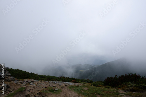 Autumn landscape in the mountains with a fog. Carpathian Mountains  Ukraine.