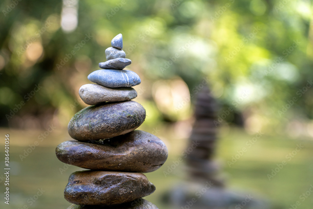 Relaxed view of a pyramid of stones balanced on a river water Relaxed view of a pyramid of stones balanced on a river water