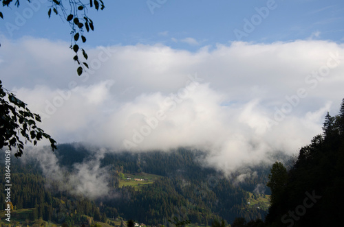 Morning autumn landscape in the mountains with a fog. Carpathian Mountains, Ukraine.