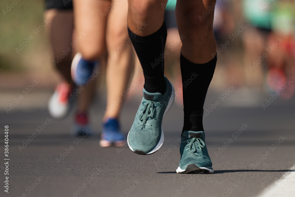 Marathon running race, people feet on city road	
