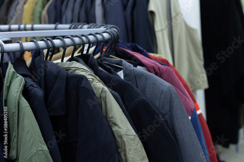 Rack with male clothes on hangers