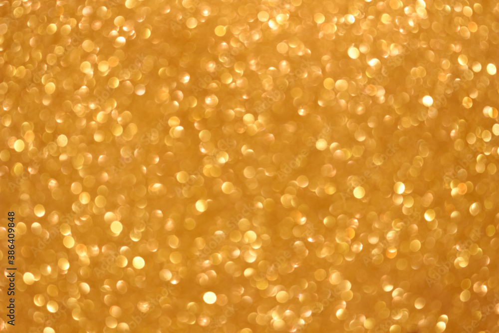 An abstract gold background with sparkle lights and bokeh. Gold blurred light. An abstract gold background with sparkle lights and bokeh. Gold blurred light.