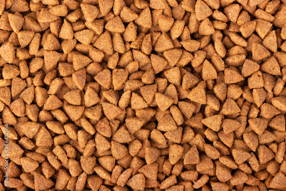 Dry pet food background. Pile of granulated animal feeds. Granules of good nutrition for dogs and cats. Dry pet food background. Pile of granulated animal feeds. Granules of good nutrition for dogs and cats.