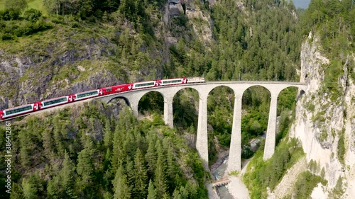 Aerial video of the Glacier Express train traversing the Landwasser viaduct. UNESCO world heritage in Switzerland photo