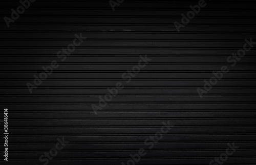grunge black steel shutter door background and texture with vignette effect. photo