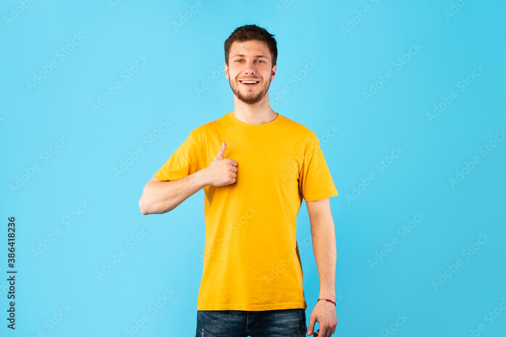 Happy man gesturing thumbs up and smiling Happy man gesturing thumbs up and smiling