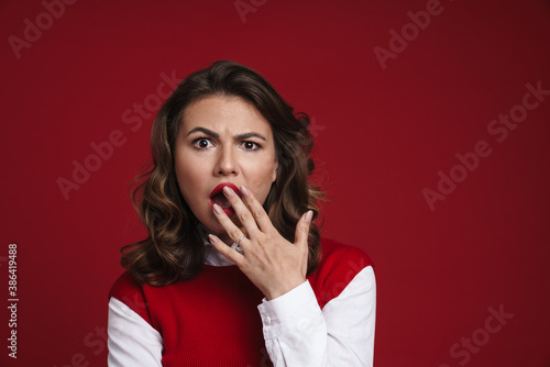 Beautiful shocked girl expressing surprise and covering her mouth