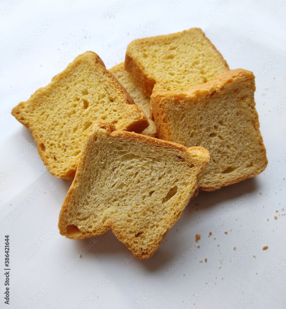 crispy rusk, cake rusk, cardamom rusk, Crunchy or Toast for healthy life, Traditional biscuit tray with tea, toasts for breakfast and cup of fresh milk & Tea, dry toasty bread, crunchy toast, pau, pav