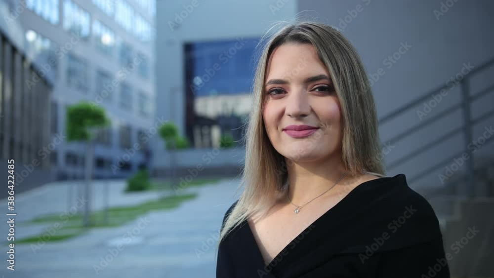 Closeup portrait of smiling businesswoman in office background. Pretty business woman, successful confidence the financial building behind. Close-up a happy blonde hair lady. Close up female outdoor Closeup portrait of smiling businesswoman in office background. Pretty business woman, successful confidence the financial building behind. Close-up a happy blonde hair lady. Close up female outdoor