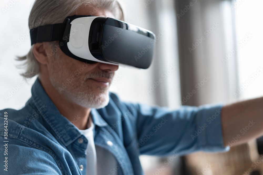 Handsome man trying vr glasses at home Handsome man trying vr glasses at home