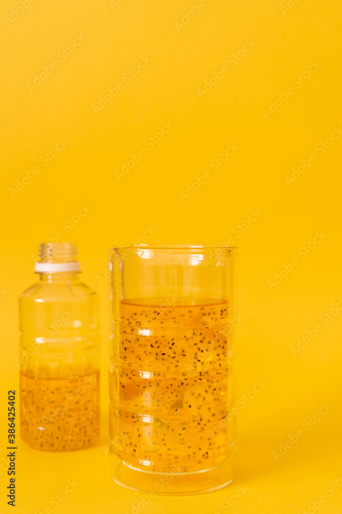 Mango drink with basil seeds with ice on a yellow background. Mango drink with basil seeds with ice on a yellow background.