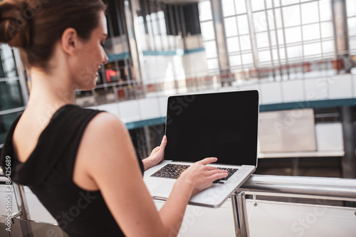 Elegant woman working with her computer in the airport