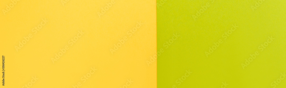 top view of colorful abstract yellow and green paper background, panoramic shot